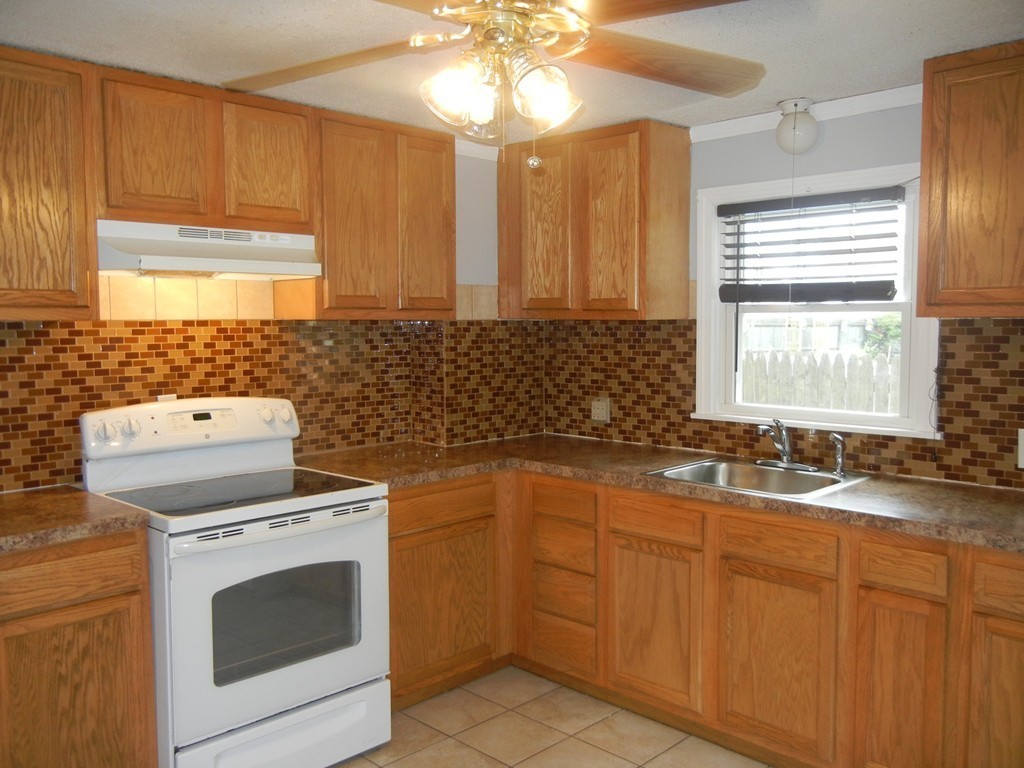 141 Freeman Terrace Springfield, MA 01104 - Photo 6 of 21 a kitchen with granite countertop a sink stove and microwave