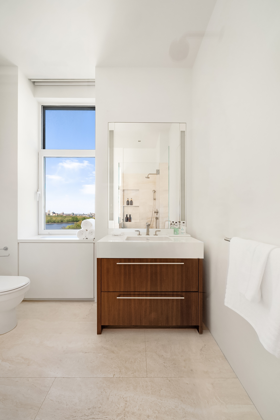 2 East 88th Street, Unit 11 Manhattan, NY 10128 - Photo 22 of 26 a bathroom with a sink vanity mirror and toilet