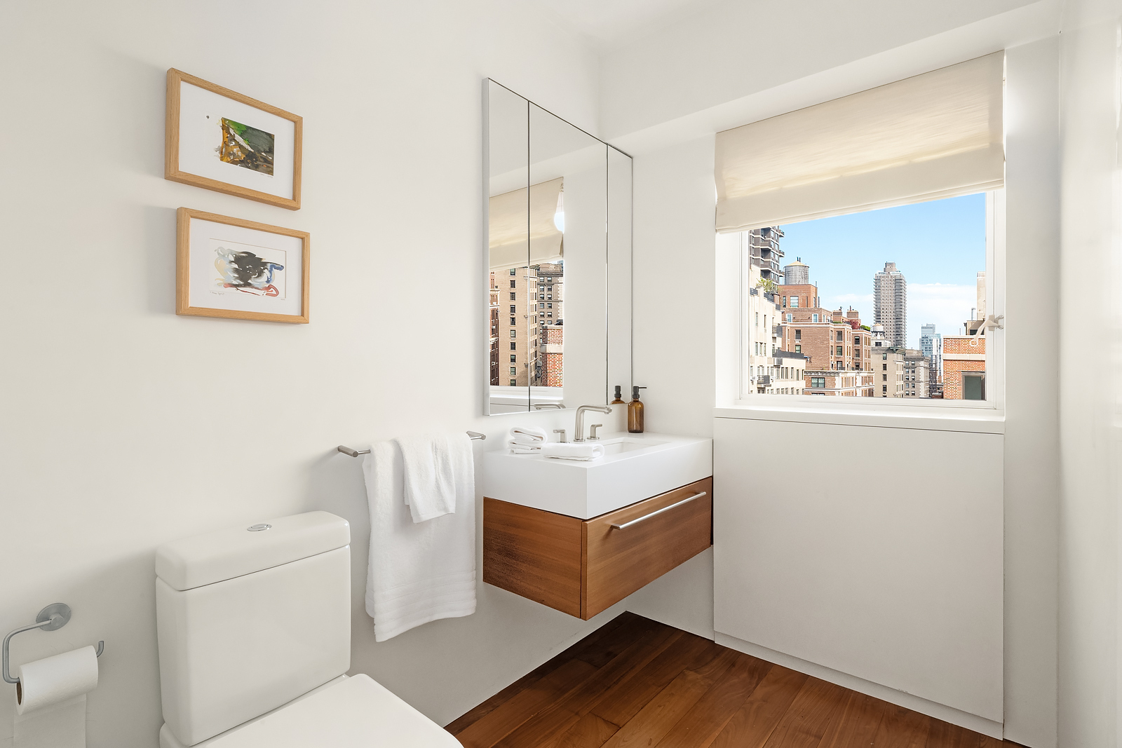 2 East 88th Street, Unit 11 Manhattan, NY 10128 - Photo 24 of 26 a bathroom with a sink a toilet and a window