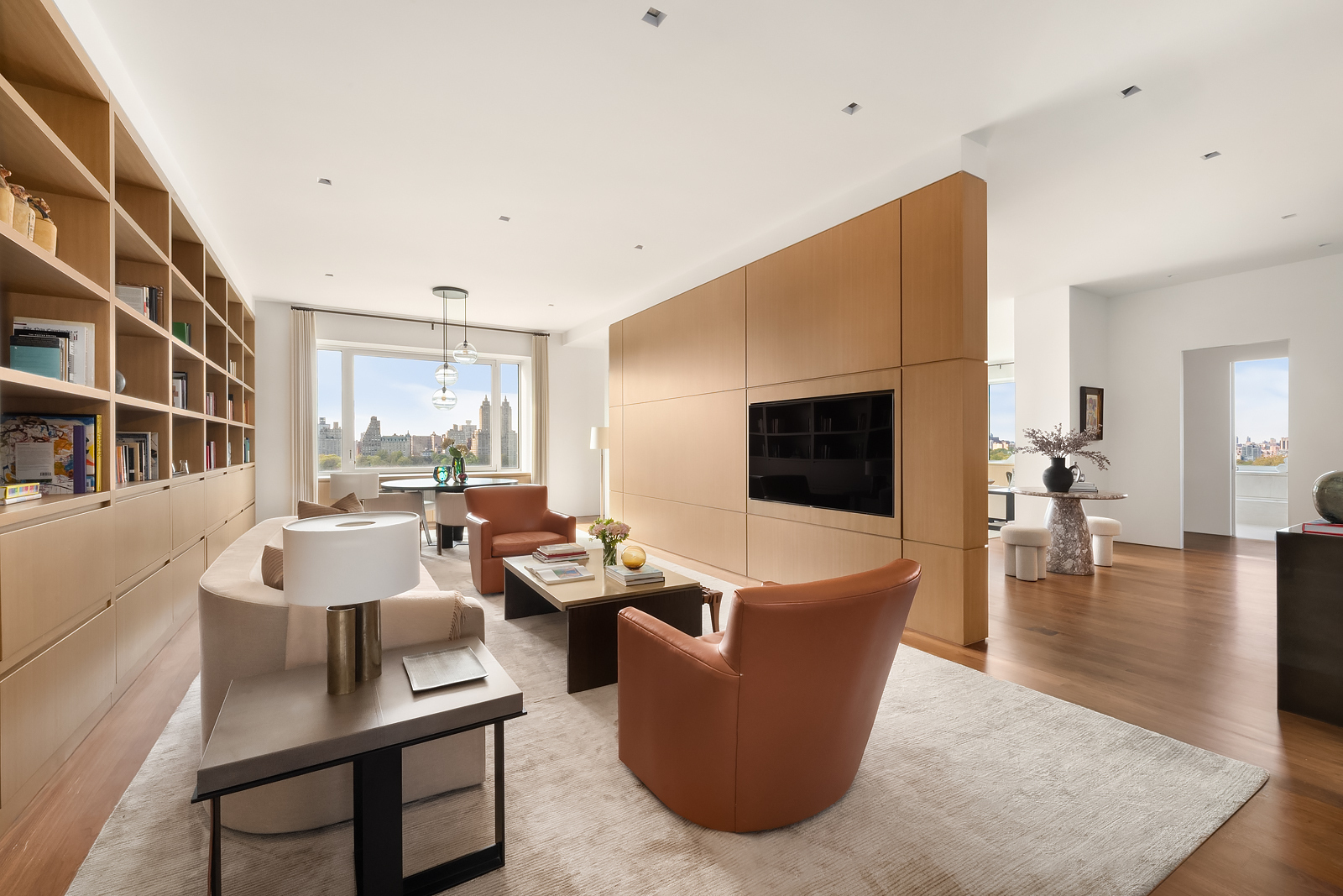 2 East 88th Street, Unit 11 Manhattan, NY 10128 - Photo 4 of 26 a living room with furniture a flat screen tv and a large window