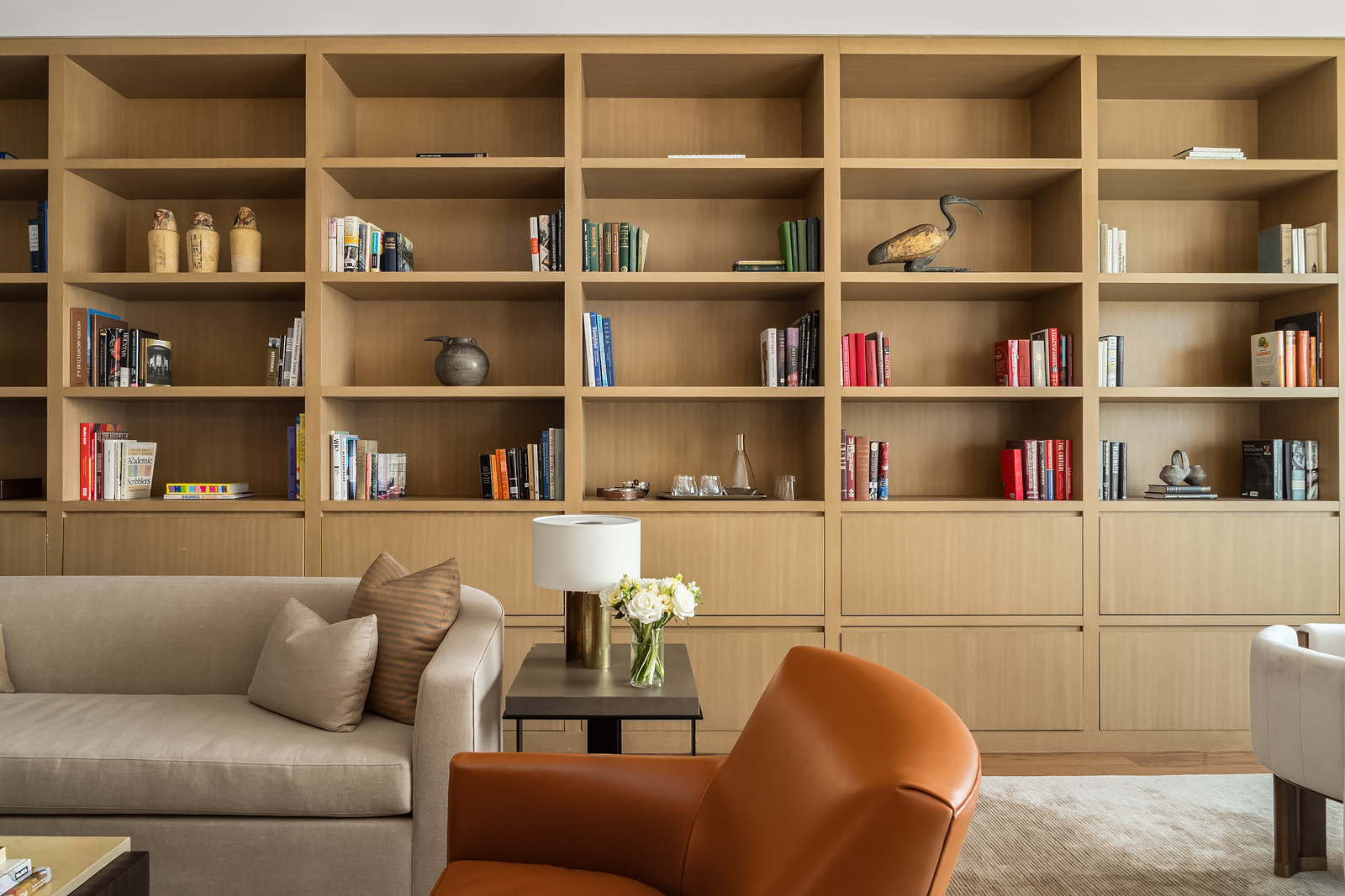 2 East 88th Street, Unit 11 Manhattan, NY 10128 - Photo 6 of 26 a living room with a book shelf