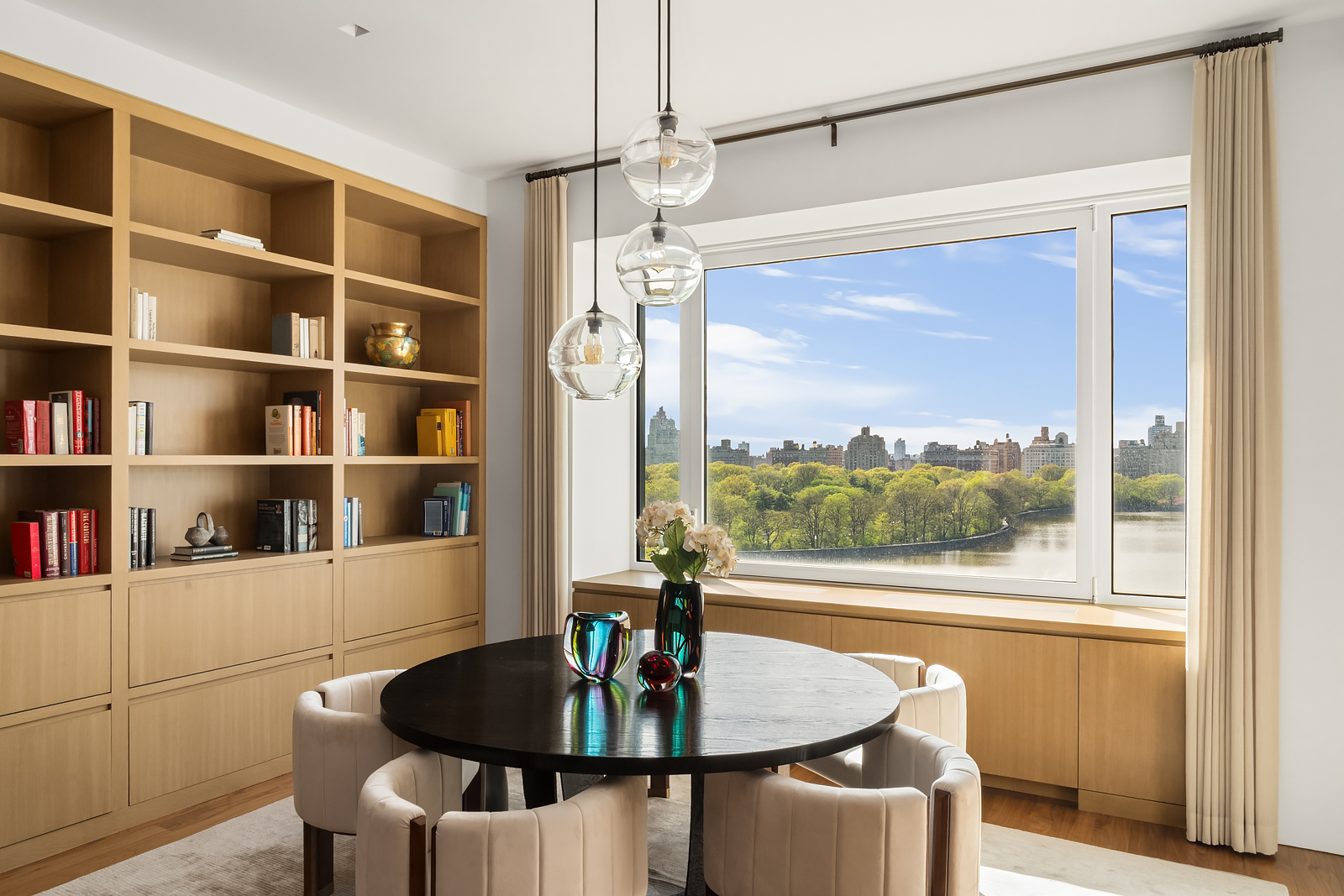 2 East 88th Street, Unit 11 Manhattan, NY 10128 - Photo 7 of 26 a dining room with furniture a window and a chandelier