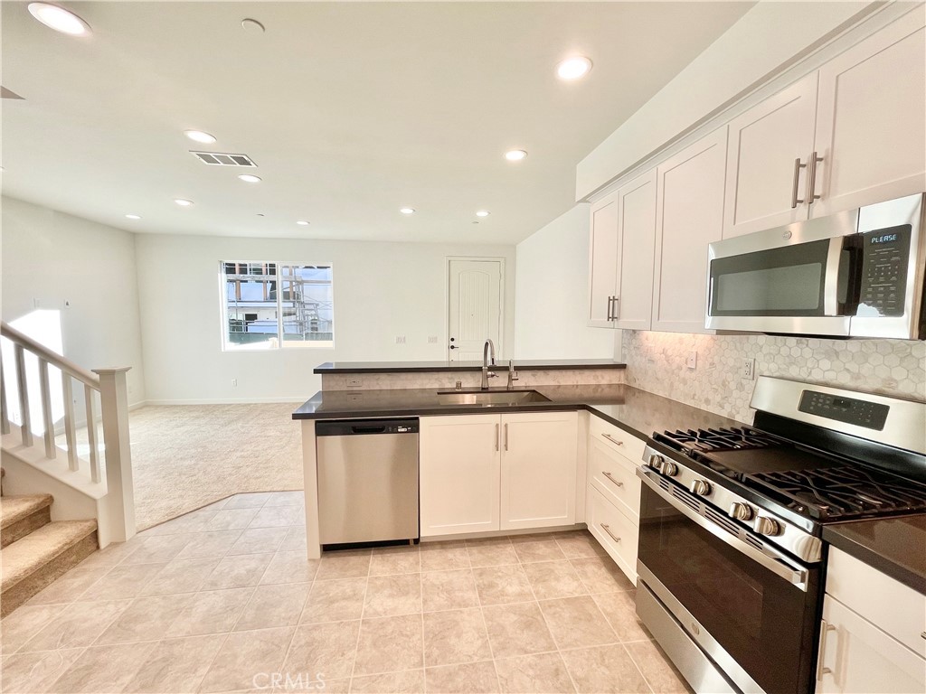 39396 Corvina Lane Temecula, CA 92591 - Photo 14 of 63 a large kitchen with stainless steel appliances granite countertop a stove and a sink