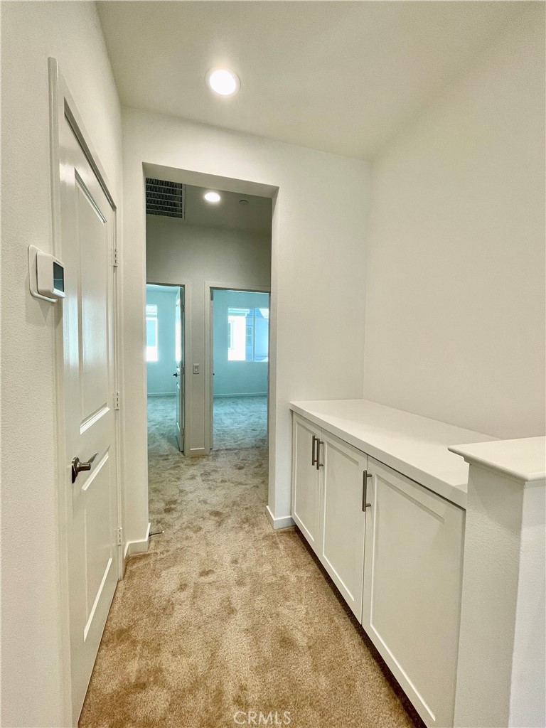 39396 Corvina Lane Temecula, CA 92591 - Photo 19 of 63 a view of a hallway with wooden floor and staircase