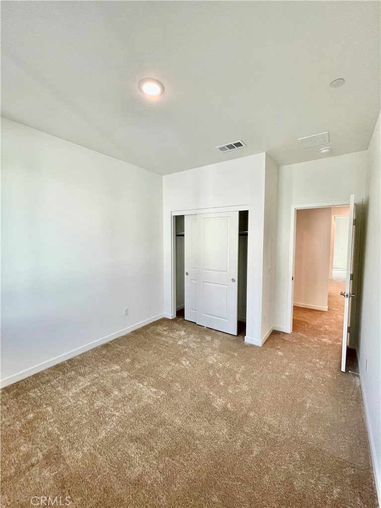 39396 Corvina Lane Temecula, CA 92591 - Photo 38 of 63 an empty room with closet and wooden door