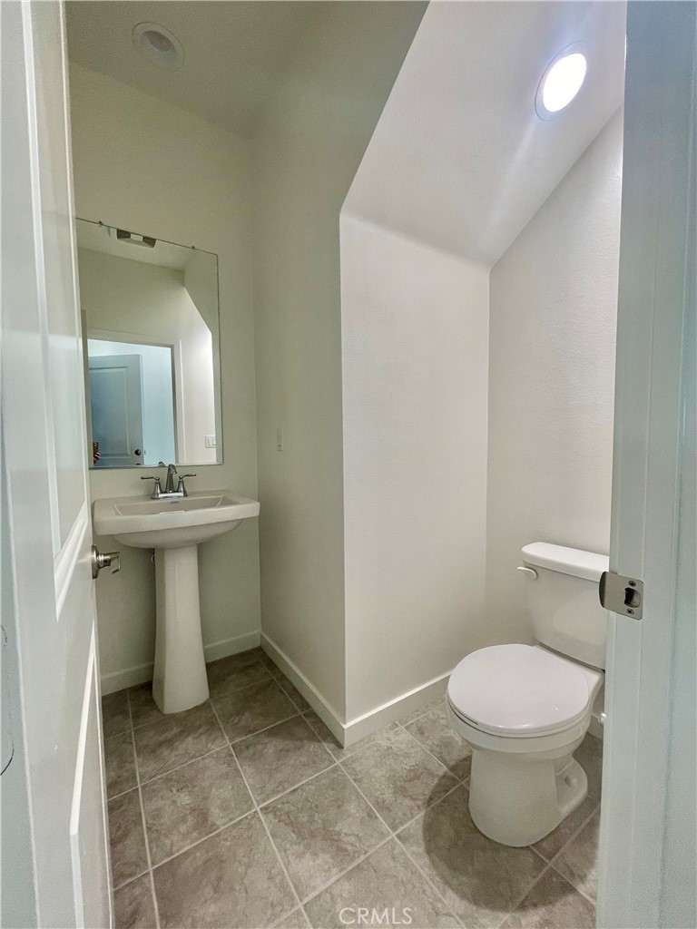 39396 Corvina Lane Temecula, CA 92591 - Photo 39 of 63 a bathroom with a sink a toilet and mirror