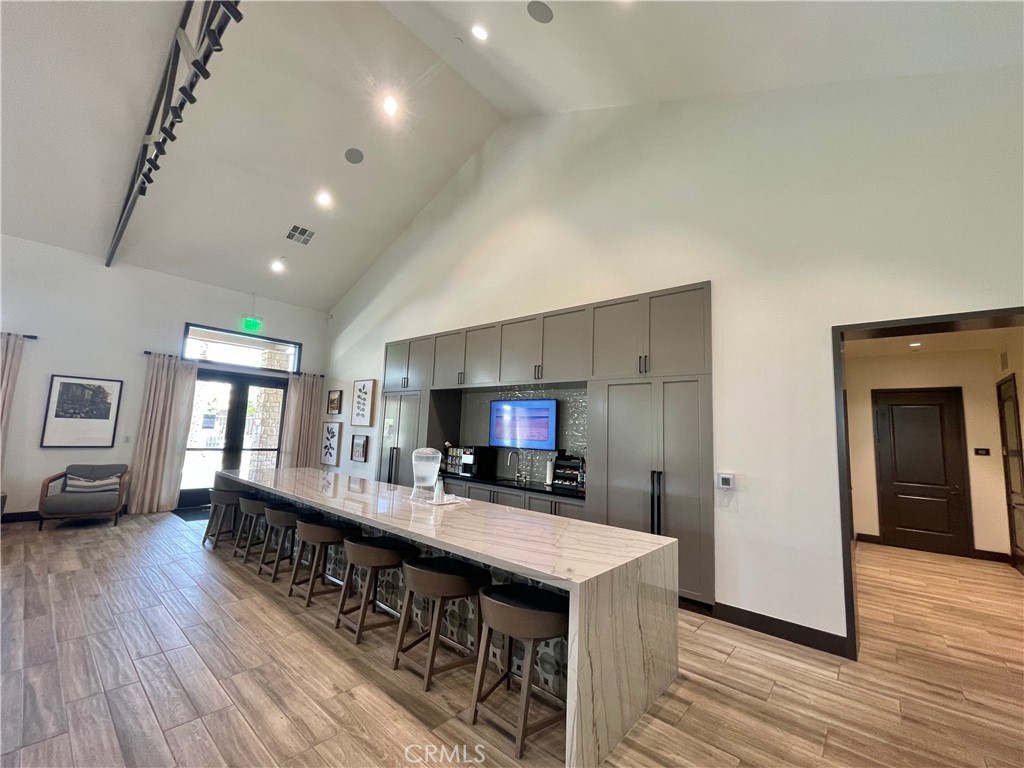 39396 Corvina Lane Temecula, CA 92591 - Photo 48 of 63 a kitchen with stainless steel appliances a sink stove and wooden floor