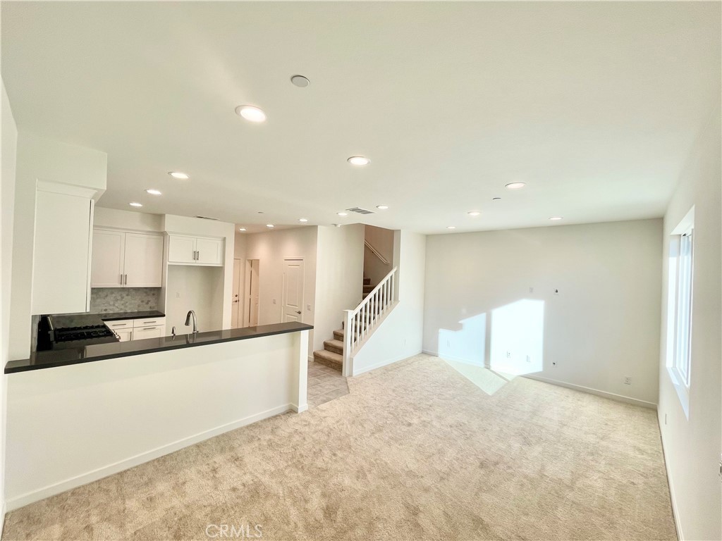 39396 Corvina Lane Temecula, CA 92591 - Photo 5 of 63 a large white kitchen with a stove a sink and a refrigerator