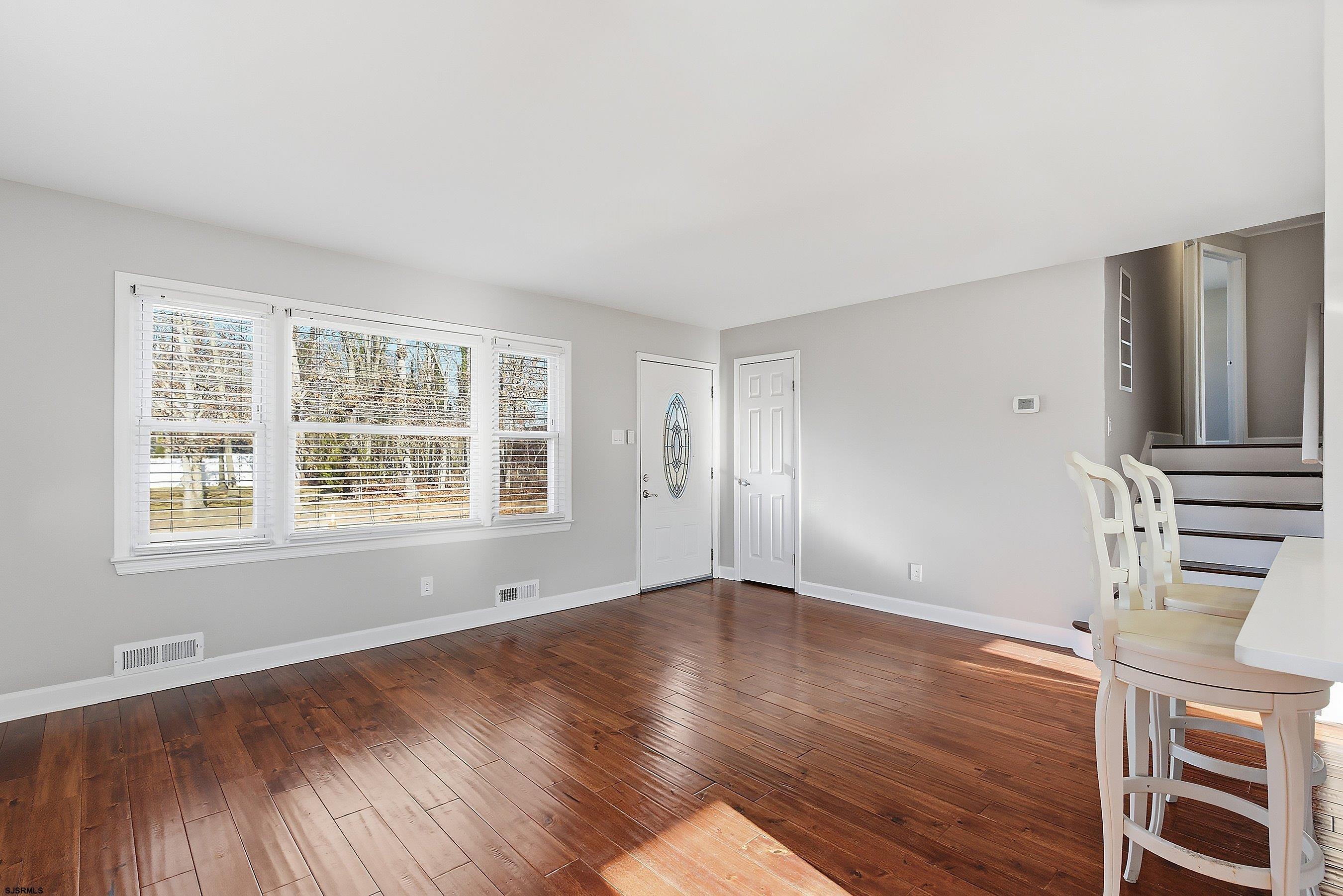 183 Jordan Road Somers Point, NJ 08244 - Photo 12 of 42 an empty room with wooden floor and windows