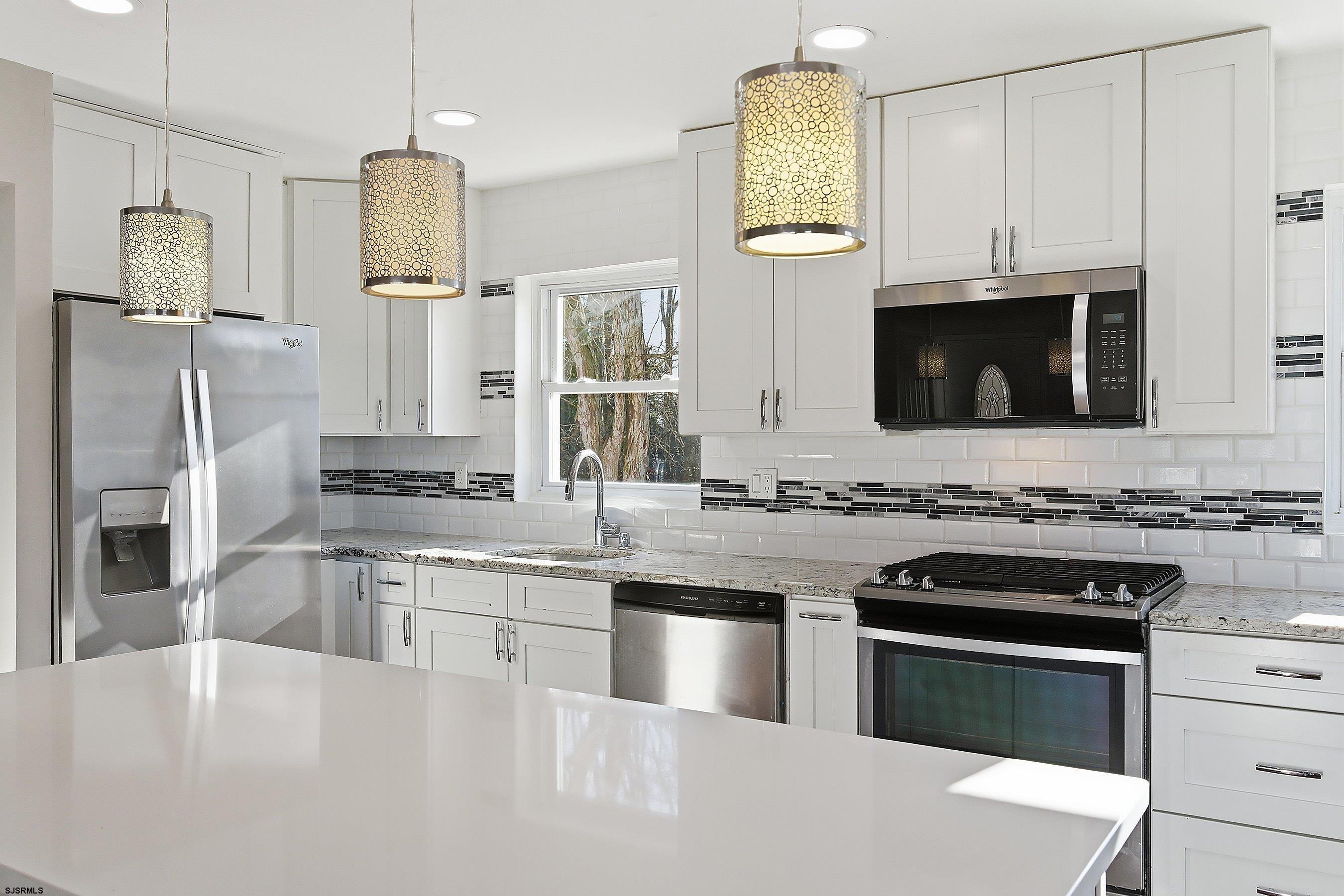 183 Jordan Road Somers Point, NJ 08244 - Photo 15 of 42 a kitchen with stainless steel appliances a stove sink microwave and refrigerator