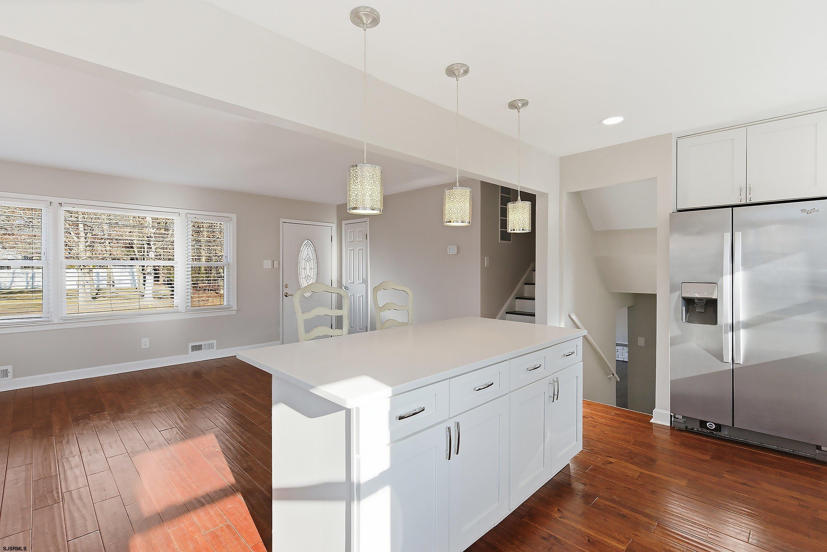 183 Jordan Road Somers Point, NJ 08244 - Photo 17 of 42 a large white kitchen with a refrigerator a sink dishwasher and a stove with wooden floor