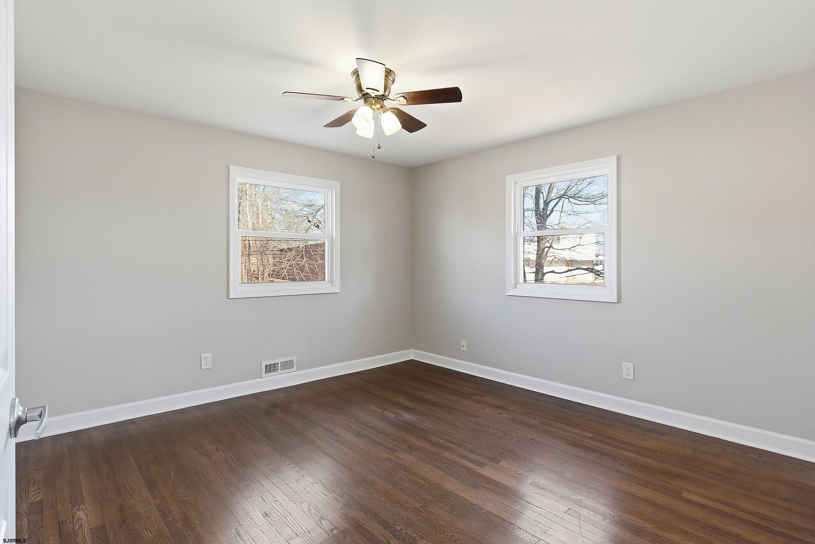 183 Jordan Road Somers Point, NJ 08244 - Photo 20 of 42 a view of a room with wooden floor ceiling fan and windows