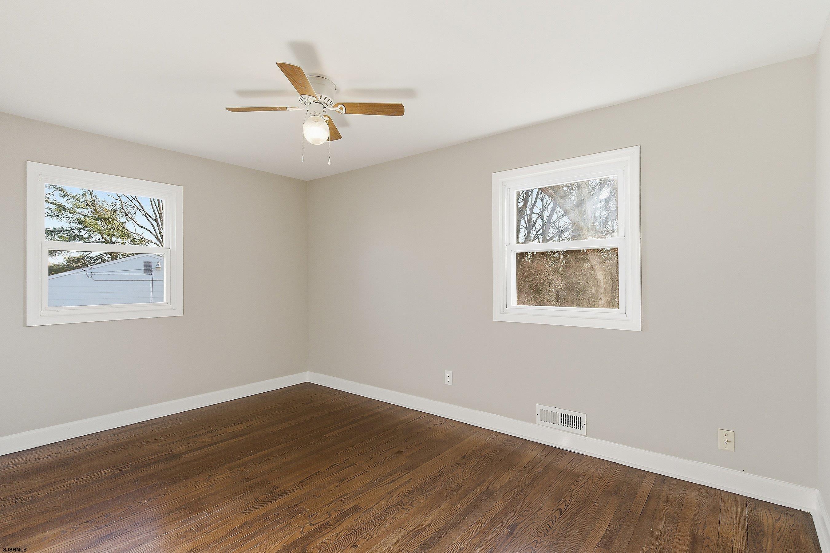 183 Jordan Road Somers Point, NJ 08244 - Photo 21 of 42 a view of an empty room with wooden floor and a window