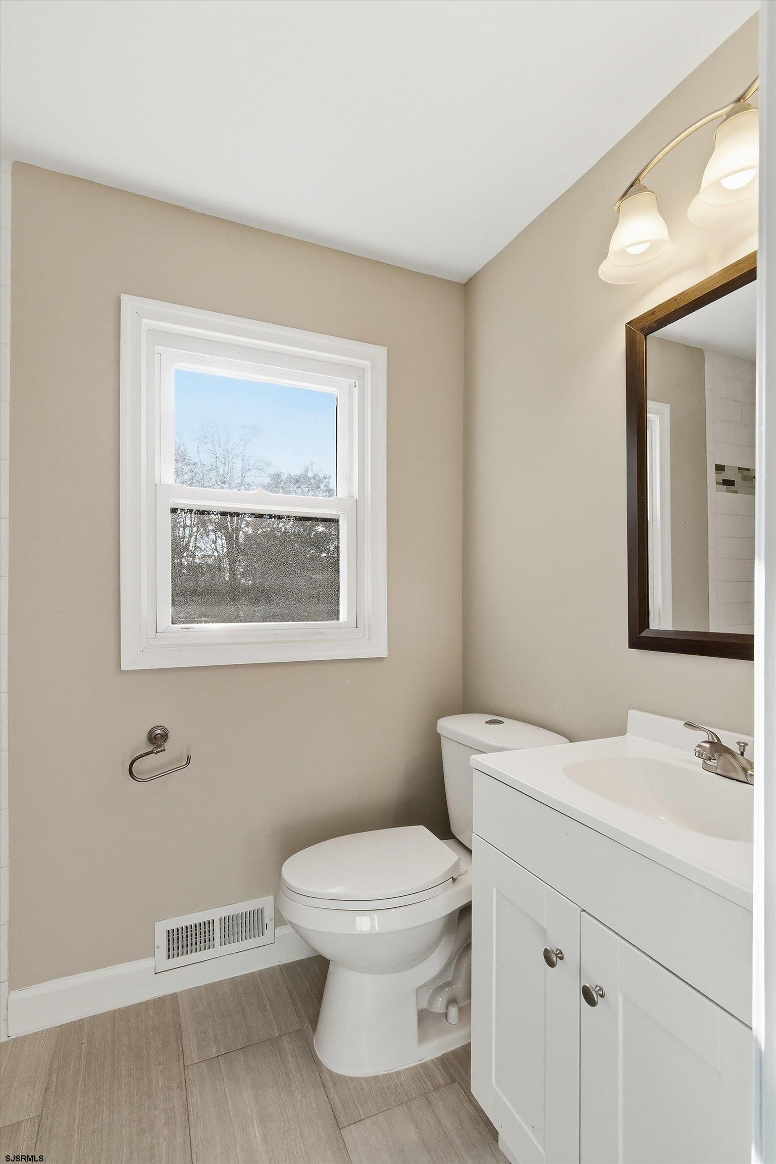 183 Jordan Road Somers Point, NJ 08244 - Photo 23 of 42 a bathroom with a toilet a sink and mirror