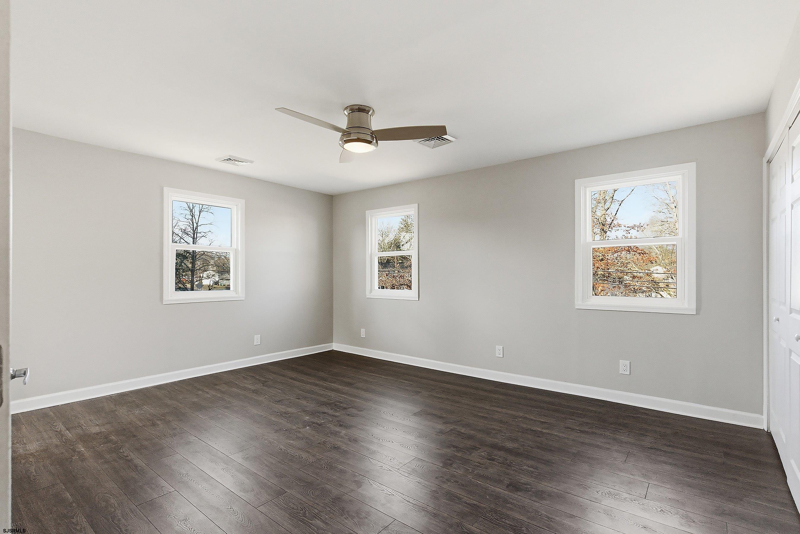 183 Jordan Road Somers Point, NJ 08244 - Photo 26 of 42 a view of an empty room with wooden floor and a window