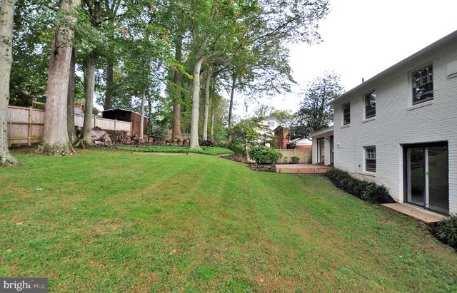 a view of a house with backyard sitting area and garden