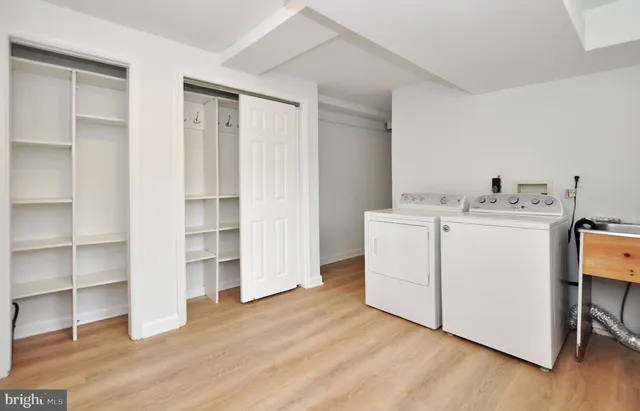 a utility room with cabinets washer and dryer