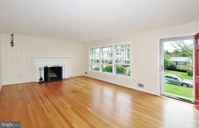 wooden floor fireplace and natural light in room
