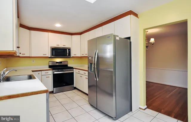 a kitchen with a refrigerator a stove and a sink