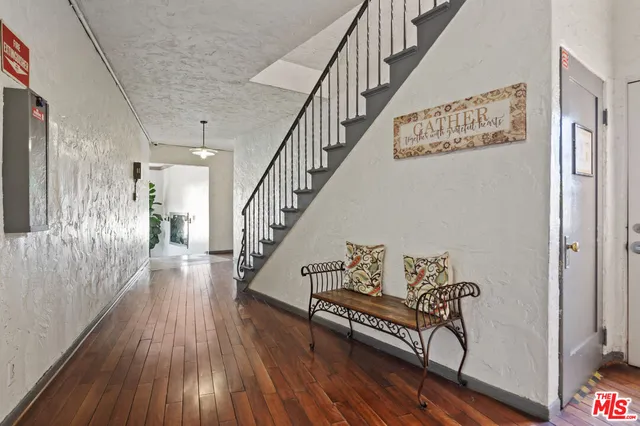 a view of entryway and hall with wooden floor