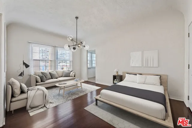 a bedroom with furniture and a chandelier