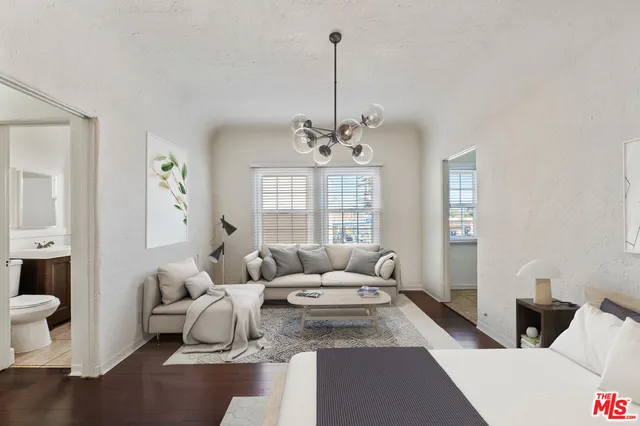 a living room with furniture and a chandelier