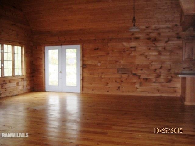 21563 Yorktown Road Chadwick, IL 61014 - Photo 4 of 23 a view of an empty room with wooden floor and a window