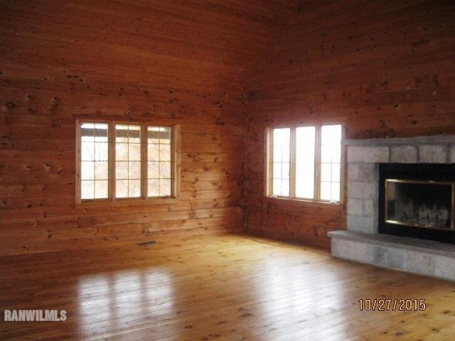 21563 Yorktown Road Chadwick, IL 61014 - Photo 5 of 23 a view of an empty room with wooden floor fireplace and a window