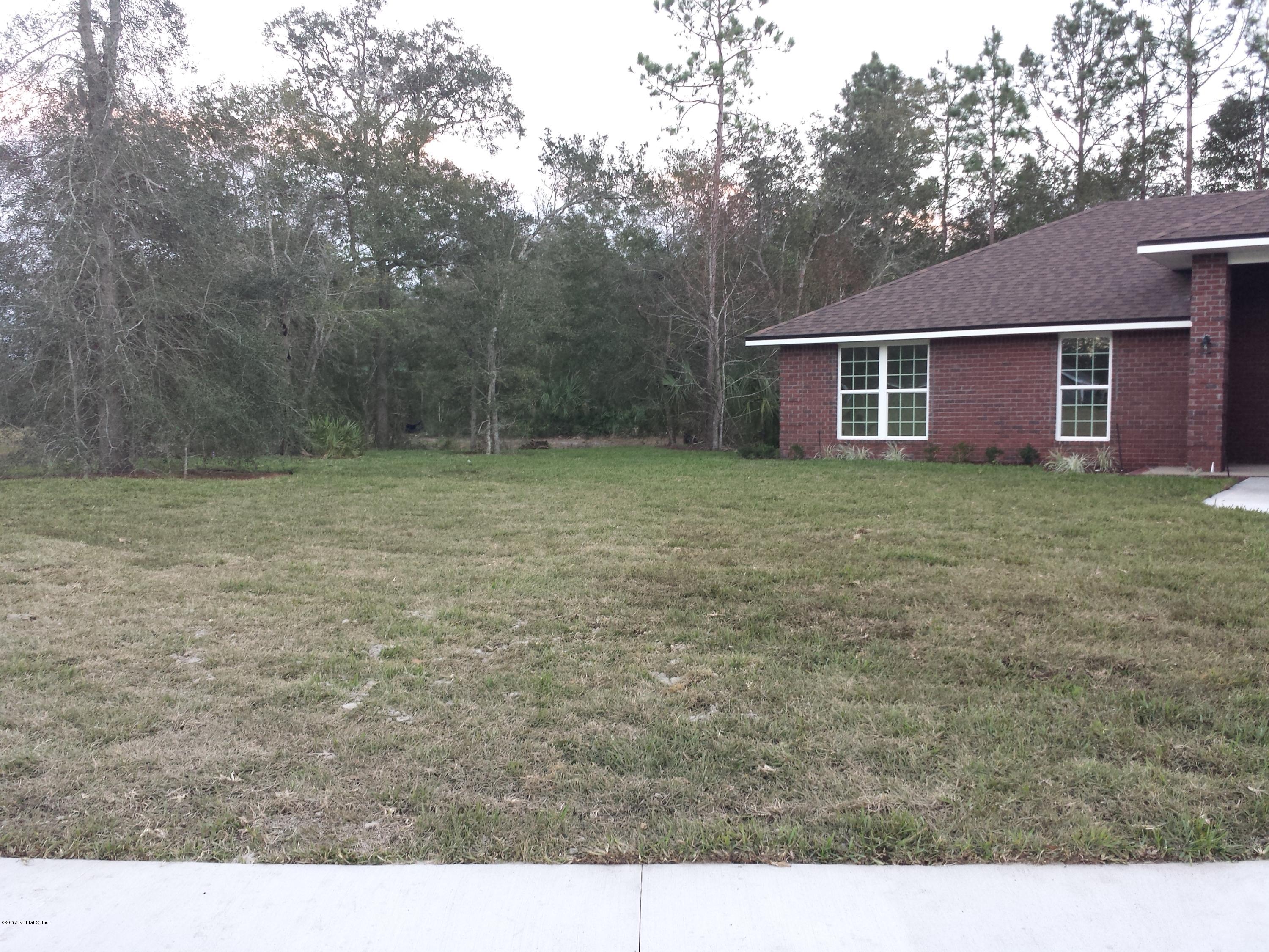 88165 Maybourne Road Yulee, FL 32097 - Photo 3 of 7 a backyard of a house