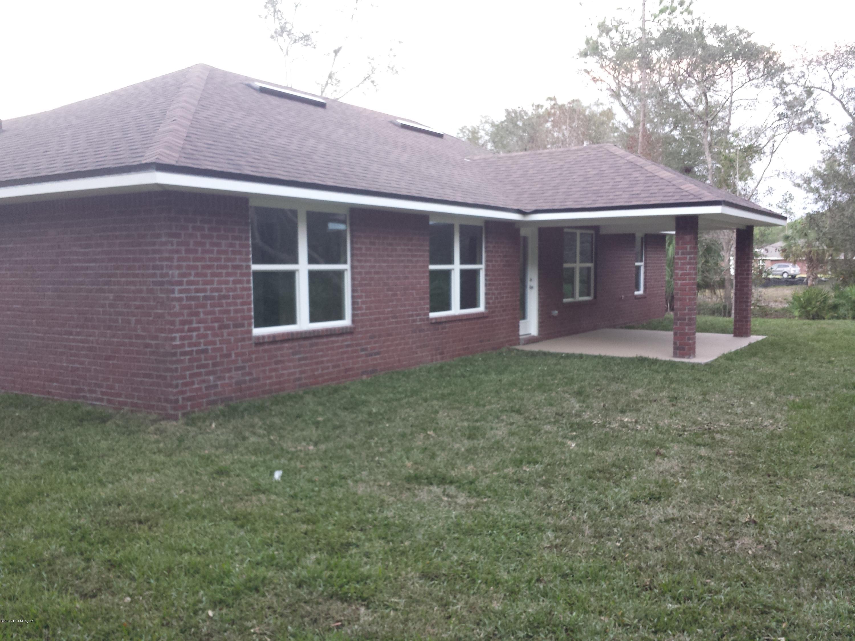 88165 Maybourne Road Yulee, FL 32097 - Photo 5 of 7 a front view of a house with garden