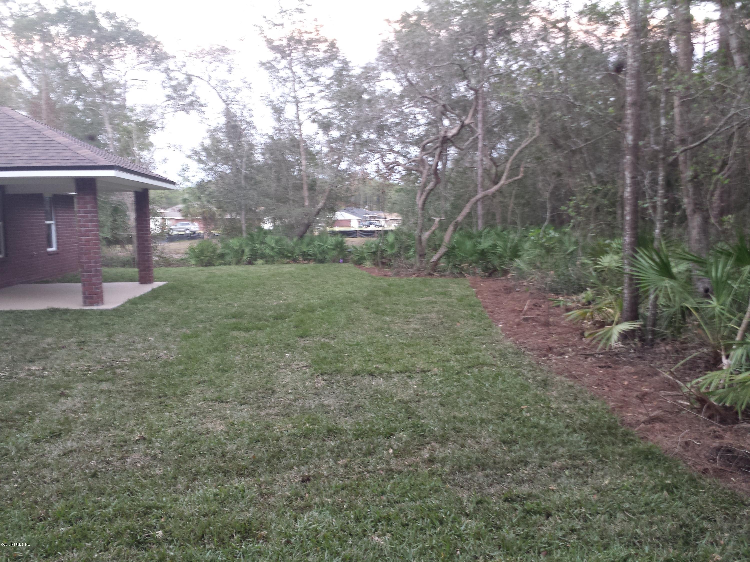 88165 Maybourne Road Yulee, FL 32097 - Photo 6 of 7 a view of a house with a yard