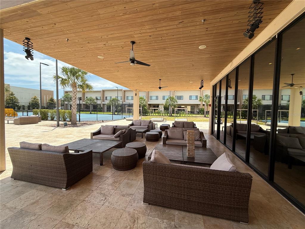 3065 Rockefeller Way Kissimmee, FL 34747 - Photo 13 of 59 a living room with patio furniture and a ceiling fan