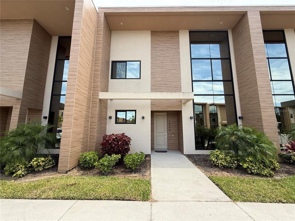 3065 Rockefeller Way Kissimmee, FL 34747 - Photo 2 of 59 a front view of a house with garden