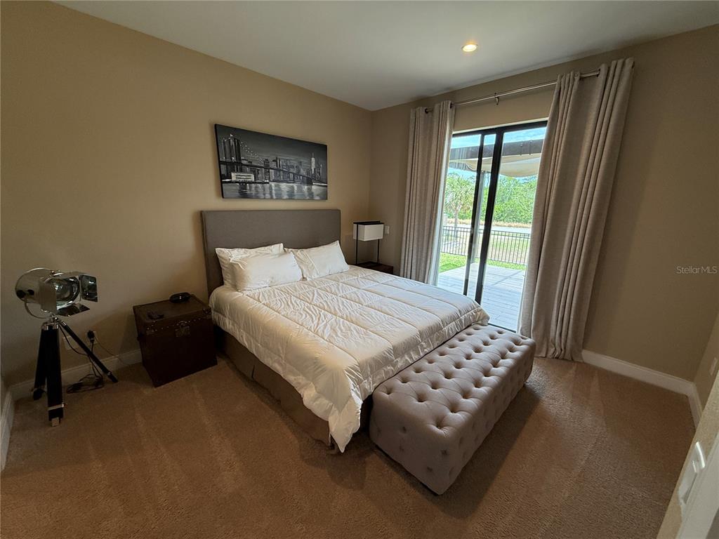 3065 Rockefeller Way Kissimmee, FL 34747 - Photo 21 of 59 a bedroom with a bed a couch and a window