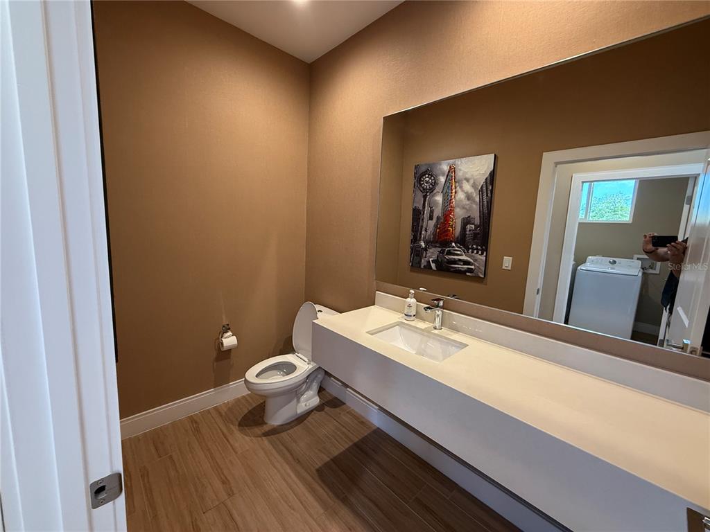 3065 Rockefeller Way Kissimmee, FL 34747 - Photo 23 of 59 a bathroom with a sink and a mirror