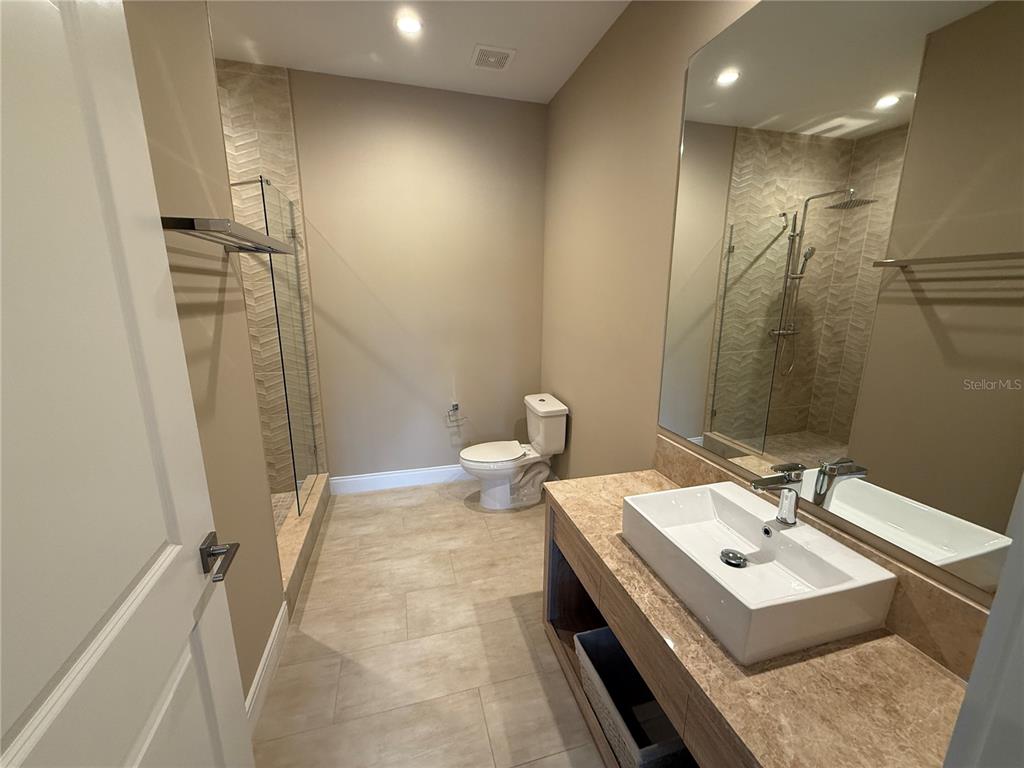 3065 Rockefeller Way Kissimmee, FL 34747 - Photo 25 of 59 a bathroom with a sink a toilet and shower