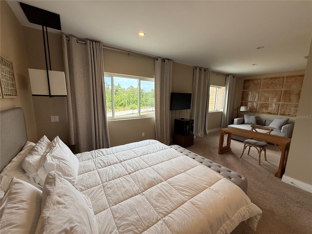 3065 Rockefeller Way Kissimmee, FL 34747 - Photo 27 of 59 a bedroom with a large bed and a window