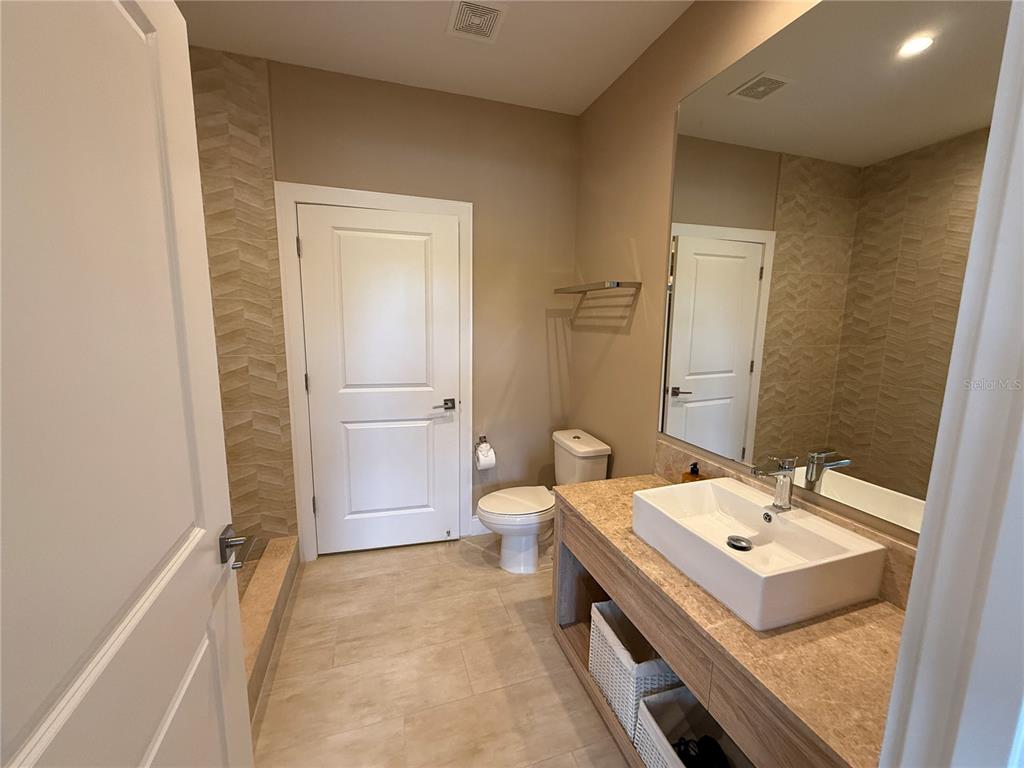3065 Rockefeller Way Kissimmee, FL 34747 - Photo 29 of 59 a bathroom with a sink a toilet and shower