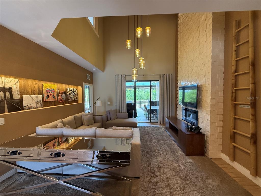 3065 Rockefeller Way Kissimmee, FL 34747 - Photo 3 of 59 a living room with furniture and a floor to ceiling window