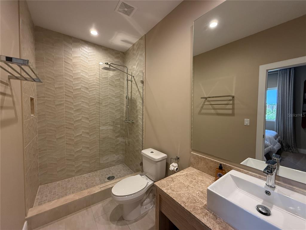 3065 Rockefeller Way Kissimmee, FL 34747 - Photo 38 of 59 a bathroom with a granite countertop toilet sink and shower