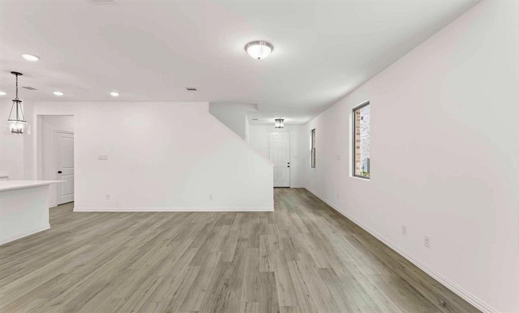 14204 Gallatin Street Pilot Point, TX 76258 - Photo 9 of 14 a view of an empty room with wooden floor