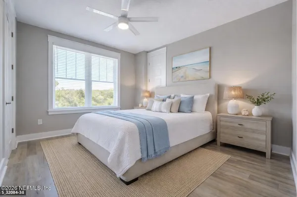 a bedroom with a bed and a night stand