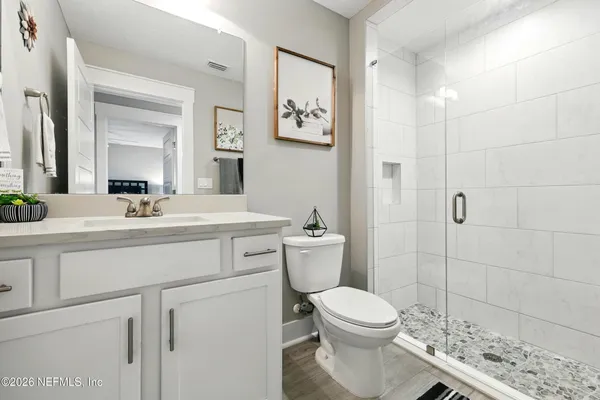 a front view of a house with a yard and trees