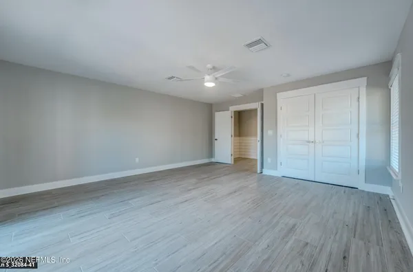 an aerial view of a house with a big yard and large trees