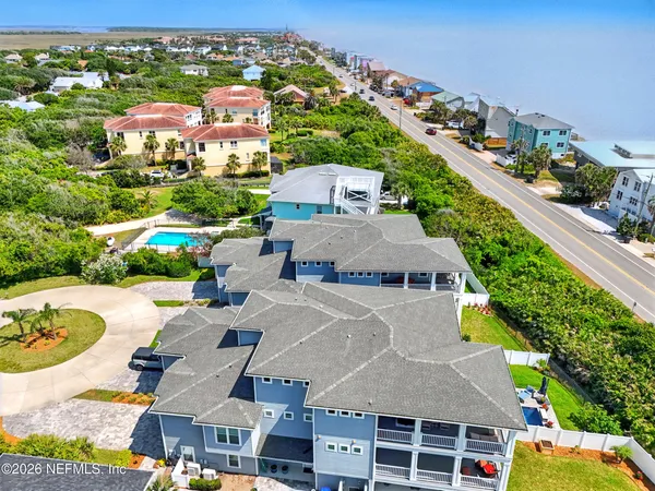 an aerial view of a house with a yard basket ball court and outdoor seating