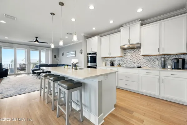 a kitchen with cabinets and chairs