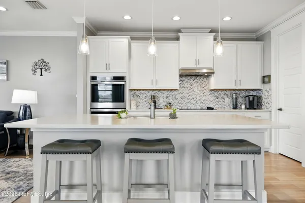 a kitchen with stainless steel appliances a stove a sink and a refrigerator
