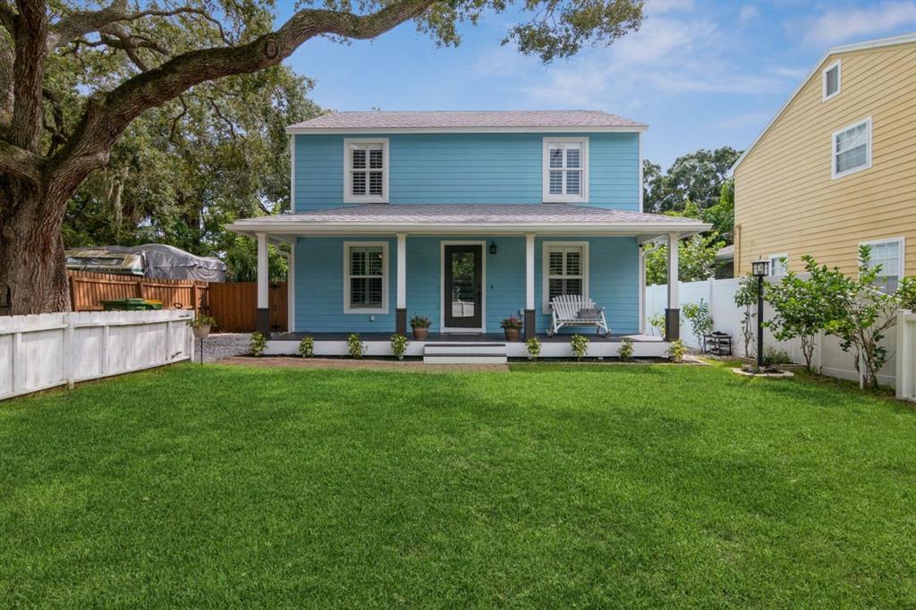 a front view of a house with yard and green space