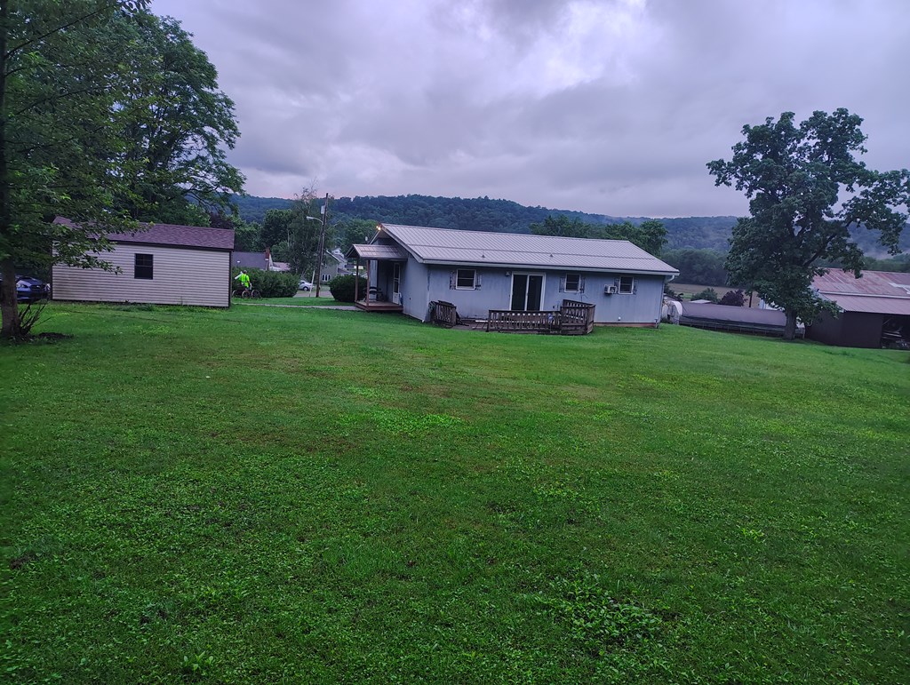 134 Railroad Street Oak Ridge, PA 16245 - Photo 5 of 20 a view of a big yard with a house in the background