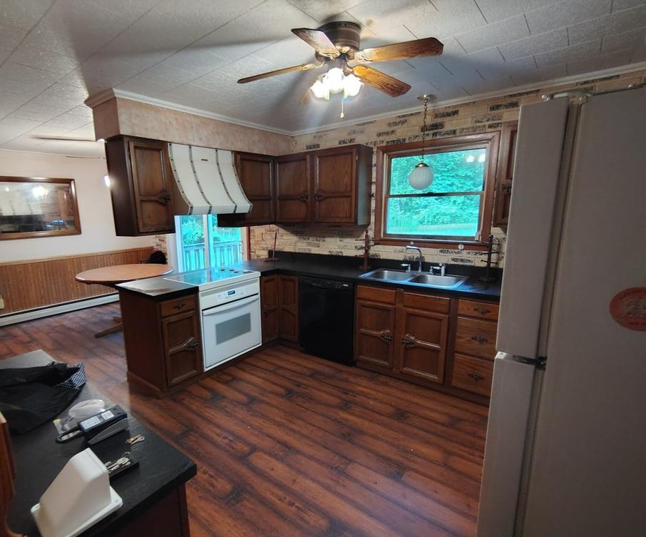 134 Railroad Street Oak Ridge, PA 16245 - Photo 6 of 20 a kitchen with stainless steel appliances kitchen island granite countertop a sink stove and refrigerator